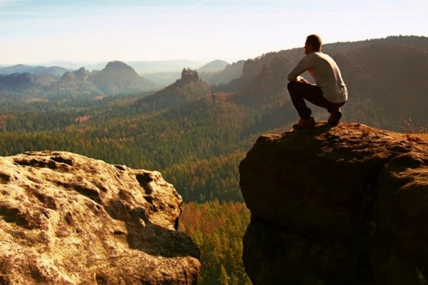 The psychology of willpower as pictured by a man on a cliff.
