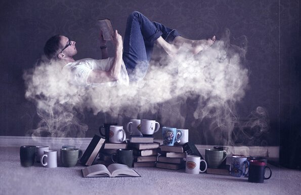 Reading and the brain: a man is reading a book on a cloud of steam from many coffee cups.