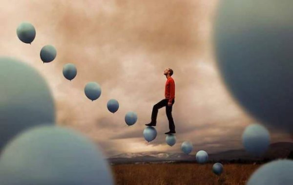 A man walking on balloons.