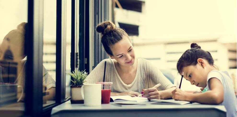 Mother and daughter are doing homework together.
