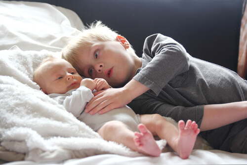 Older siblings: a baby and his older brother.