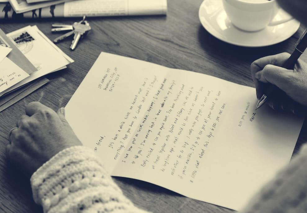 A person is writing a letter by hand.