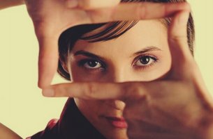 woman looking through fingers
