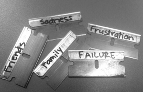 Self-injury with razor blades.