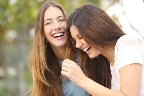 Sisters laughing together.