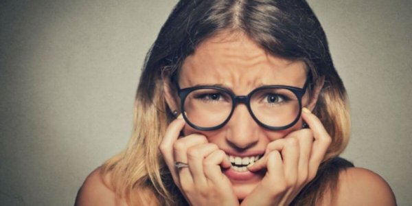 a nervous woman biting her nails