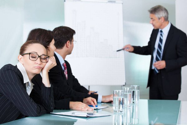 a woman asleep at a work meeting
