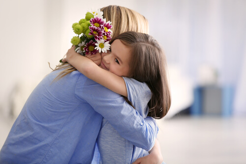 A mother and her little daughter hugging on Mother's day.