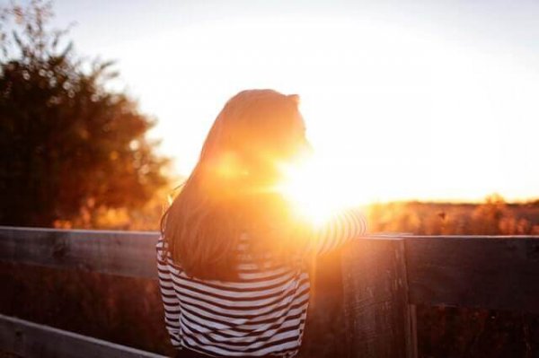 a woman at sunset