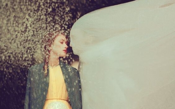 a couple, the man covered up with a white sheet