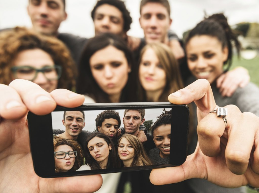 A group of friends is taking a selfie.