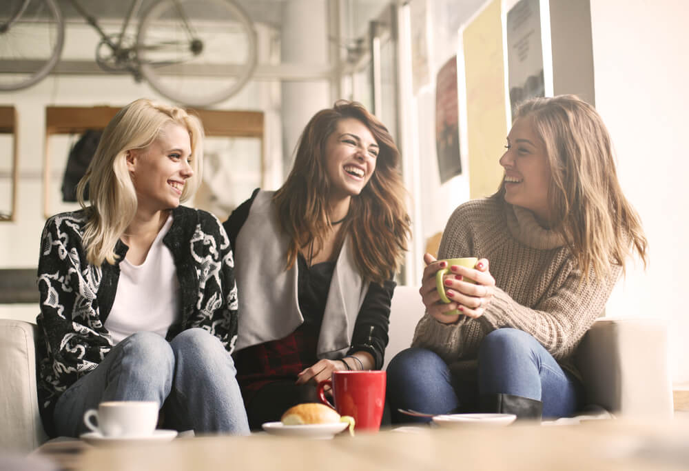 A group of girlfriends is laughing together.