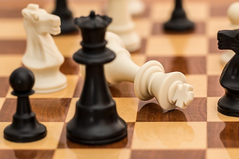 A white king surrendering in chess.