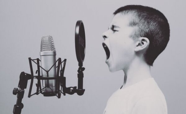 A child yelling into a microphone.