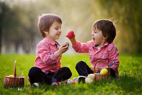Social skills in children: two kids playing with Easter eggs.