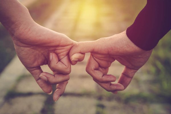 Holding hands with pinkies.