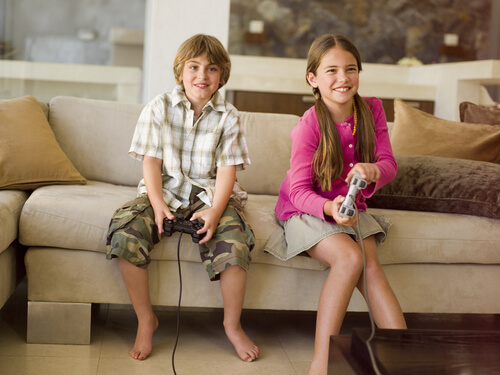 A girl and a boy are playing video games.