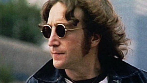 John Lennon wearing dark glasses.