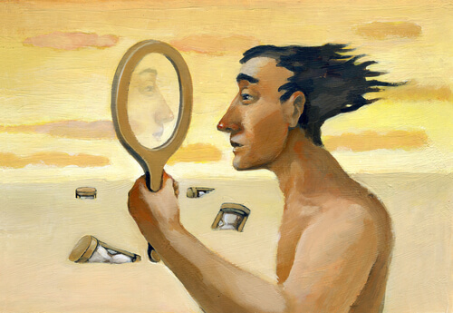 Man looking into a mirror in a desert.