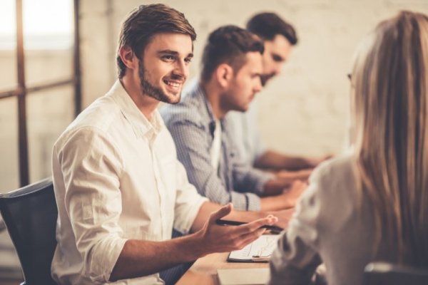 A man smiling at a colleague.