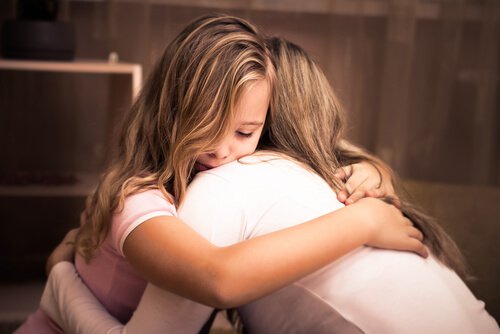 A mother and daughter are hugging.