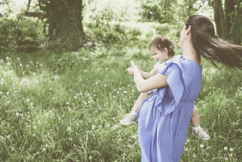 A pregnant woman with a little girl.