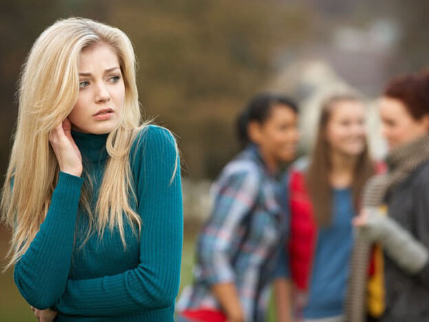 A paranoid girl with a crowd of friends behind her.