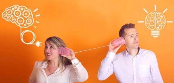 Playing telephone: a man and a woman's brains communicating.