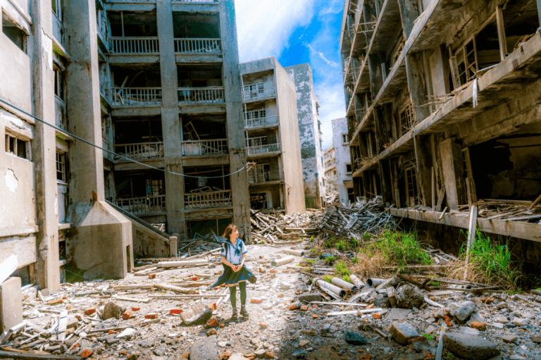 A school girl is walking through ruins.