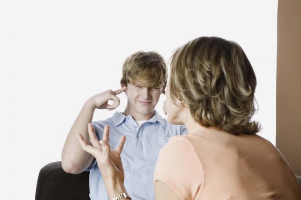 Teen covering his ears