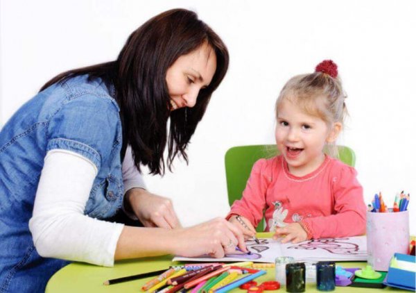 Child psychology woman coloring with child