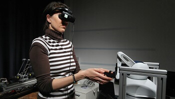 Woman manipulating a robot.