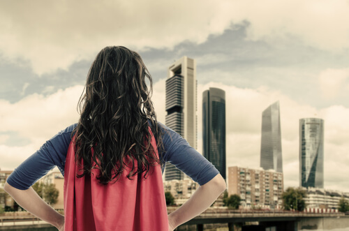 Woman wearing a superhero cape.