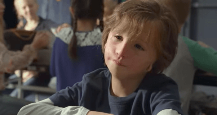 August Pullman sitting in a classroom.