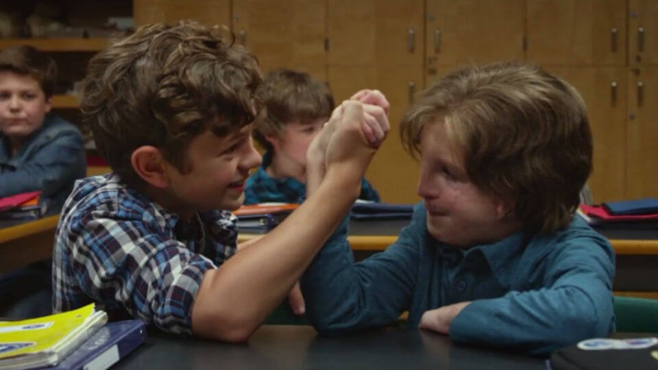 The protagonist of the movie Wonder playing with a friend.