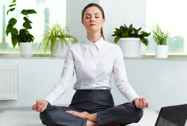 A business woman meditating.