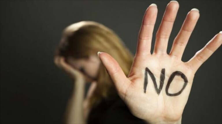 A woman with NO written on her hand.