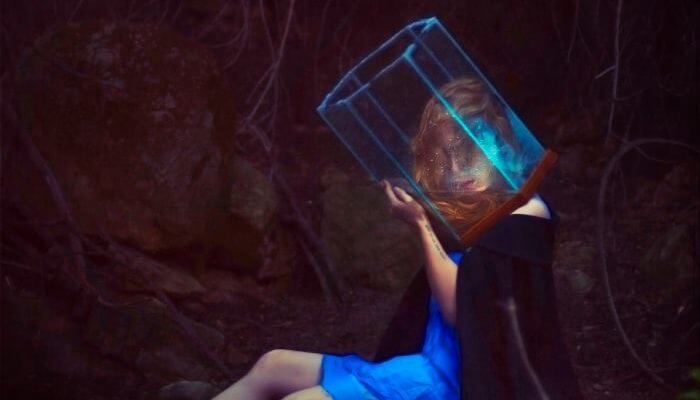 A woman with a cube of water on her head.