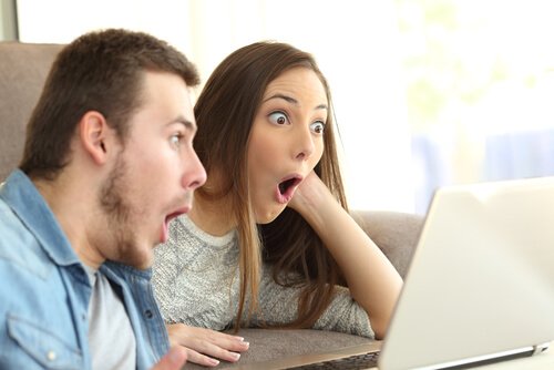 Amazed couple in front of computer