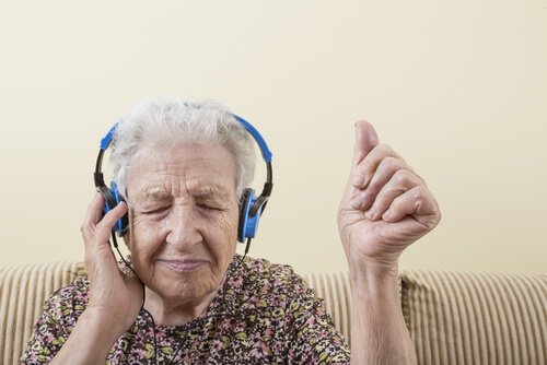 An elderly woman is listening to music.
