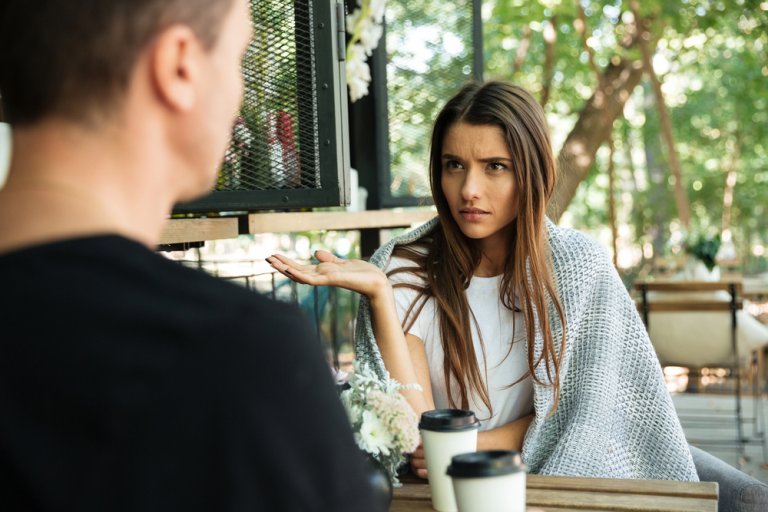 An upset woman is talking to her spouse.