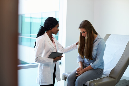 A doctor with a young woman.