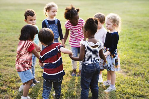 Children holding hands in a circle.