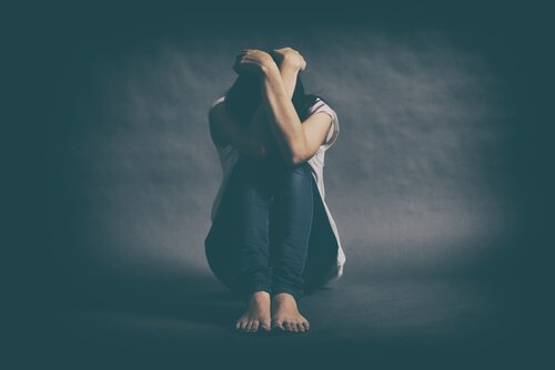 Depressed woman head in hands