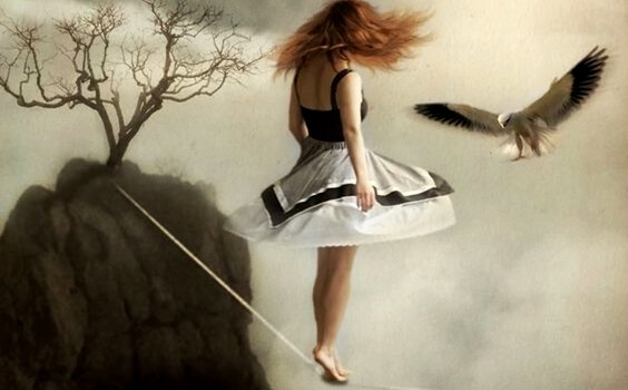 A girl is crossing a tightrope.