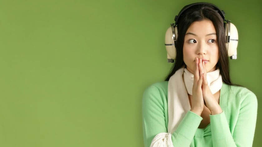 A girl is wearing headphones.