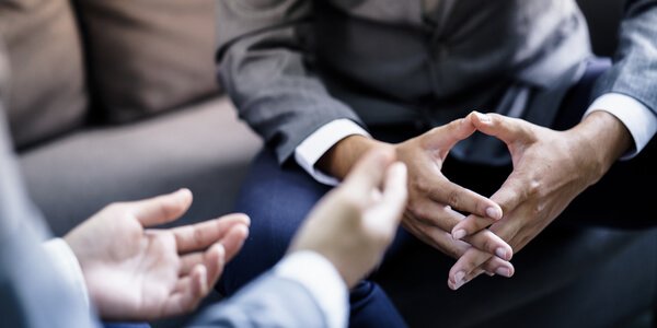 Two pairs of hand during a conversation.