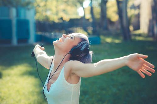 Happy woman listening to music: self-realization.