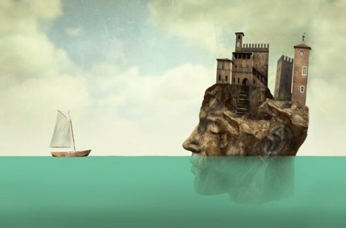 A big stone head in the ocean.