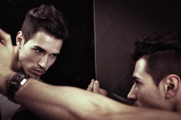 A vain man looking in the mirror.
